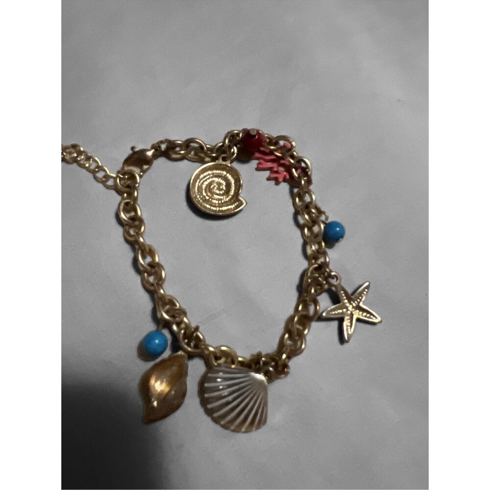 shell charms and hanging colorful beads. Super cute vintage charm bracelet.